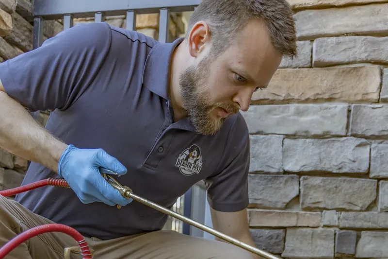 Berner Pest Solutions inspector examining a Lexington home for evidence of wood destroying insects