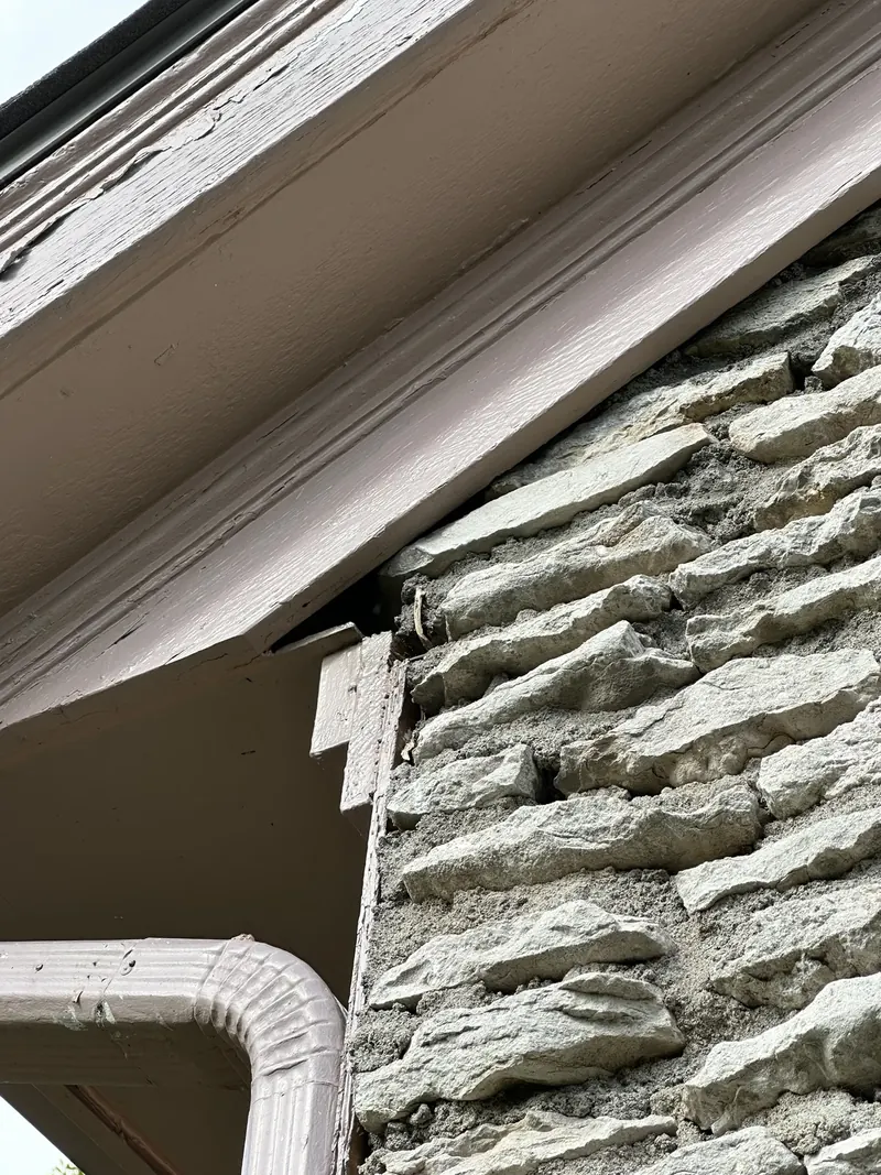 Gap behind a frieze board where mice can enter the attic